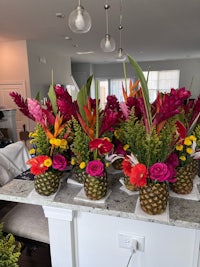 a kitchen with colorful flowers in vases